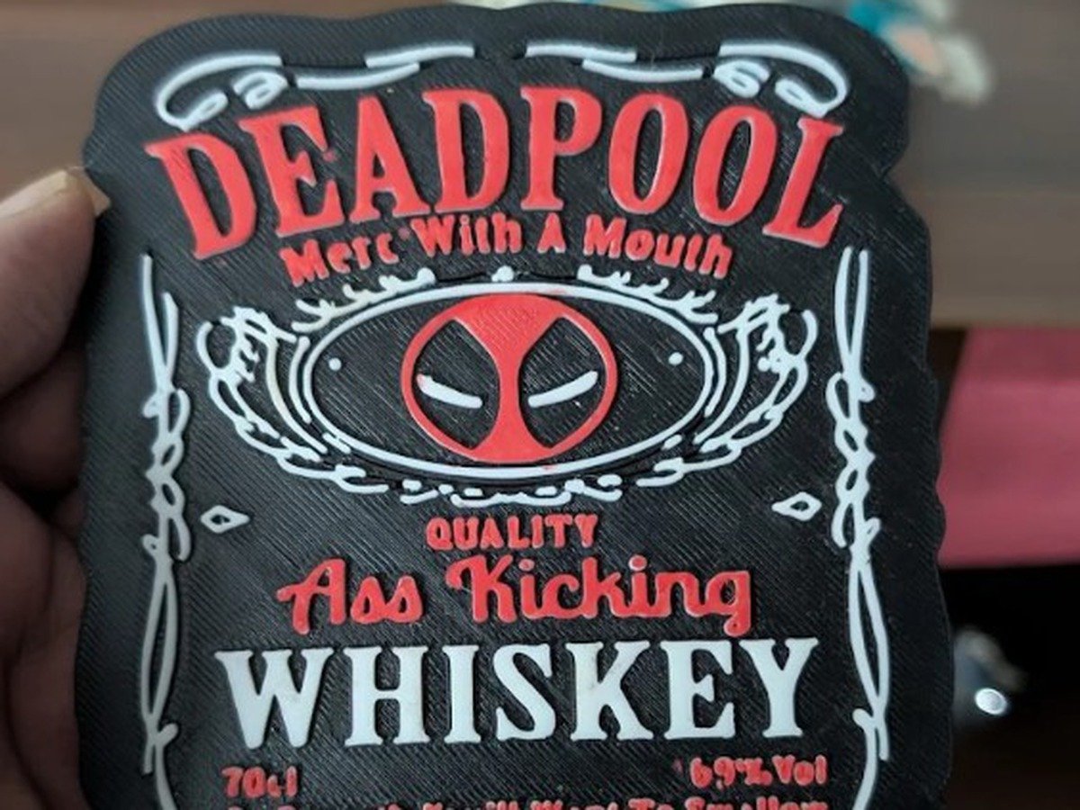 Custom 3D printed Deadpool whiskey-label coaster in black, red, and white PETG